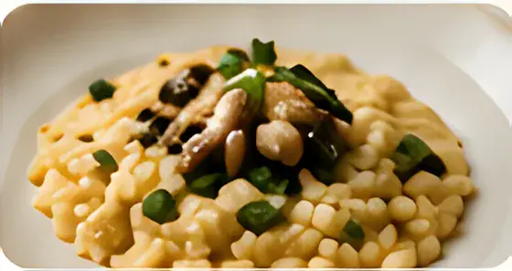 Creamy mushroom risotto topped with sautéed mushrooms and herbs