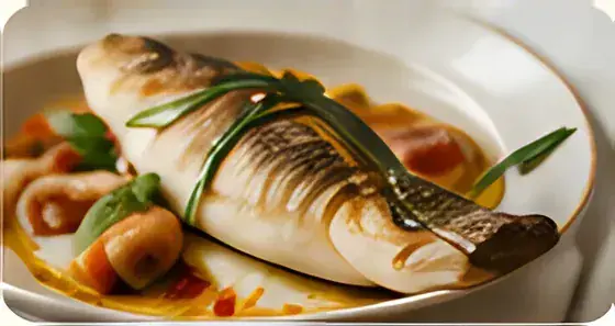 Grilled sea bass fillet with roasted vegetables and lemon